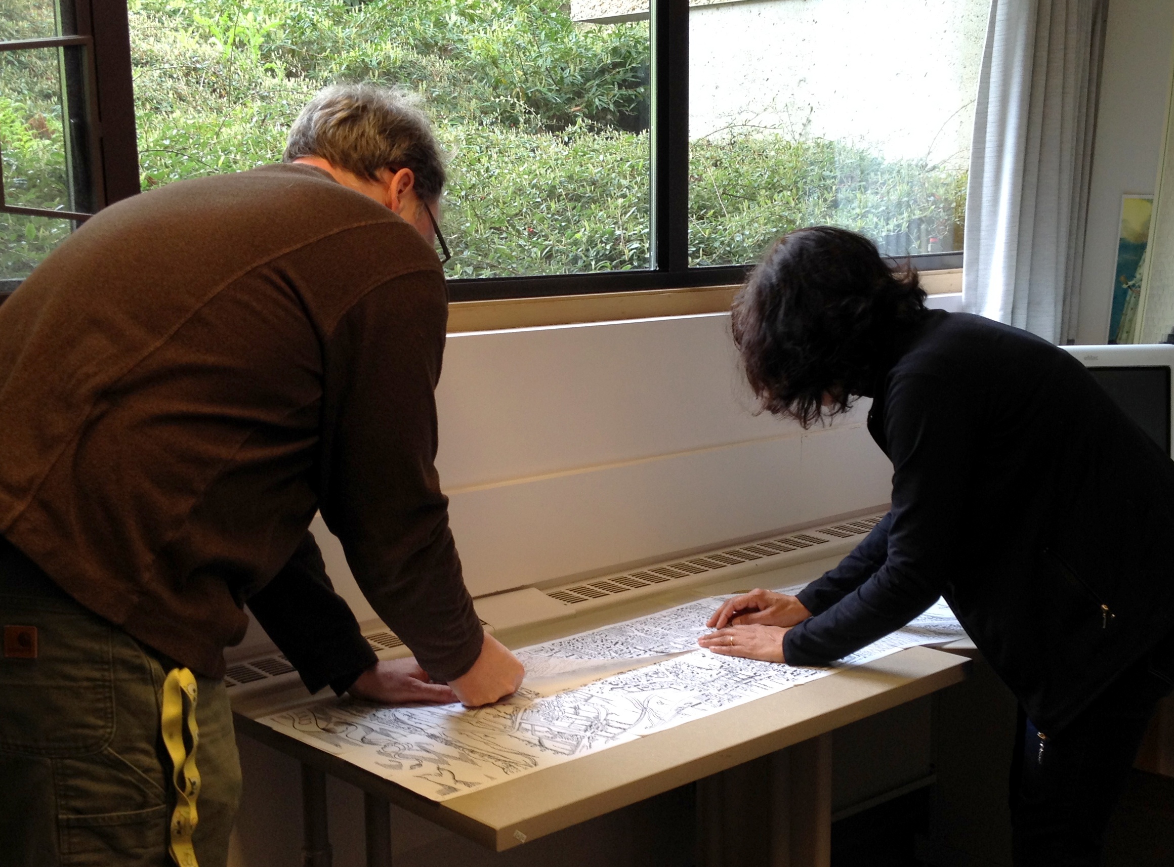 Greg Newton and Jillian Player stitching the
                        map